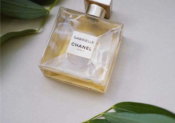 smaller perfume surrounded by leaves